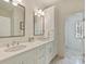 Elegant bathroom featuring double sinks, quartz countertops, and custom cabinetry and natural light at 2616 Colton Dr, Charlotte, NC 28211