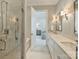 Bright bathroom featuring double vanity, a shower and a view into the main bedroom at 2616 Colton Dr, Charlotte, NC 28211
