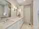 Bright bathroom with double vanity, sconces, and neutral color palette at 2616 Colton Dr, Charlotte, NC 28211