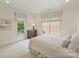 Cozy bedroom bathed in natural light showcasing neutral tones, window views, and simple, elegant furnishings at 2616 Colton Dr, Charlotte, NC 28211