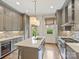 Kitchen with a large center island, stainless steel appliances, and custom gray cabinets at 2616 Colton Dr, Charlotte, NC 28211
