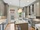 Contemporary kitchen with gray cabinets, a large island, and stainless steel range at 2616 Colton Dr, Charlotte, NC 28211
