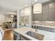 Open kitchen with gray cabinets, stainless appliances, hardwood floors, and a view of living room at 2616 Colton Dr, Charlotte, NC 28211