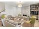 Stylish living room featuring a stone fireplace, built-in bookcase, and comfortable seating arrangement at 2616 Colton Dr, Charlotte, NC 28211