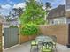 Cozy brick-walled patio with a dining table and seating, perfect for intimate gatherings and outdoor relaxation at 2616 Colton Dr, Charlotte, NC 28211