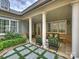 Beautifully designed porch showcasing white pillars, and a relaxing outdoor seating space with lush greenery at 2616 Colton Dr, Charlotte, NC 28211