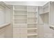 Bright walk-in closet with white shelving, drawers, and ample storage space at 2616 Colton Dr, Charlotte, NC 28211