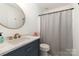 Well-lit bathroom featuring modern fixtures, stylish vanity, and a shower at 2630 Park Rd # H, Charlotte, NC 28209