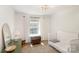 Bright bedroom featuring playful wallpaper, a white crib, and a cozy feel at 2630 Park Rd # H, Charlotte, NC 28209