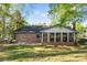 Exterior view of home featuring a brick facade and an enclosed sunroom at 2643 Providence Dr, Gastonia, NC 28052