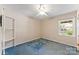 Bright bedroom with a ceiling fan, light walls, blue carpet, and a window view at 2643 Providence Dr, Gastonia, NC 28052
