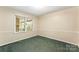 This is a cozy bedroom with green carpet and natural light from a window at 2643 Providence Dr, Gastonia, NC 28052