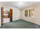 This is a bedroom with green carpet and a glimpse of the kitchen through the door at 2643 Providence Dr, Gastonia, NC 28052