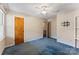 Bedroom with blue carpet, ceiling fan, closet, and a view into another room at 2643 Providence Dr, Gastonia, NC 28052