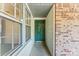 A green front door framed by white wood paneling and brick walls at 2643 Providence Dr, Gastonia, NC 28052