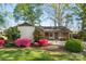 Charming brick home featuring mature landscaping and a cozy front porch at 2643 Providence Dr, Gastonia, NC 28052