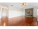 Spacious living room with hardwood floors and a stone fireplace as its centerpiece at 2643 Providence Dr, Gastonia, NC 28052