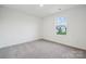 Bright bedroom with neutral carpet and a large window showcasing neighborhood at 285 Bezelle Ave, York, SC 29745