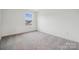 Bright bedroom with neutral carpet and a large window showcasing neighborhood at 285 Bezelle Ave, York, SC 29745