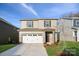 Inviting two-story home featuring a two-car garage and well-manicured lawn at 285 Bezelle Ave, York, SC 29745