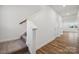 Bright hallway featuring hardwood floors, stairs and white trim at 285 Bezelle Ave, York, SC 29745