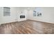 Open living room featuring an electric fireplace, hardwood floors and natural light at 285 Bezelle Ave, York, SC 29745