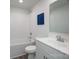 This bathroom features a clean, modern look, with a white vanity and neutral-toned tile at 2890 Westshore Pl, Denver, NC 28037