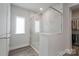 This is a bathroom featuring a glass enclosed shower with marble tile and next to a walk in closet at 2890 Westshore Pl, Denver, NC 28037