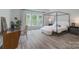This is a spacious bedroom with a four-poster bed, wood floors, and bright natural light at 2890 Westshore Pl, Denver, NC 28037