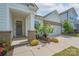Charming home featuring a welcoming front entrance with a gray door and neatly landscaped flower beds at 2890 Westshore Pl, Denver, NC 28037