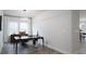 Bright home office features modern desk, chair, and ample natural light from the large windows at 2890 Westshore Pl, Denver, NC 28037