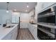 Kitchen featuring modern appliances, white cabinets, and a large island at 2890 Westshore Pl, Denver, NC 28037