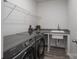 Functional laundry room with modern Samsung washer and dryer, built-in sink, and wire shelving at 2890 Westshore Pl, Denver, NC 28037