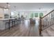 Bright, open-concept living space boasts hardwood floors, large windows, and a modern staircase at 2890 Westshore Pl, Denver, NC 28037