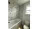Stylish bathroom with a tub and modern hexagonal tiling in the shower at 3214 Mcharney Dr # 34, Harrisburg, NC 28075