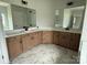 Bathroom featuring double sinks, spacious countertop, stylish vanity, and tiled flooring at 3214 Mcharney Dr # 34, Harrisburg, NC 28075
