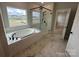 Bathroom featuring a soaking tub and glass shower with matte black trim, and marble floors at 3214 Mcharney Dr # 34, Harrisburg, NC 28075
