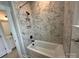 Bathroom with a tile accent wall around a white tub, and black fixtures at 3214 Mcharney Dr # 34, Harrisburg, NC 28075