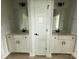 Bright bathroom with dual sinks, white cabinets and trim, modern black hardware and light fixtures at 3214 Mcharney Dr # 34, Harrisburg, NC 28075
