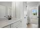 A full bathroom boasts a white vanity, a shower, and a doorway that looks into a bedroom at 3214 Mcharney Dr # 34, Harrisburg, NC 28075