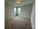 This bedroom offers cozy carpet, a ceiling light, and two windows that provide natural light at 3214 Mcharney Dr # 34, Harrisburg, NC 28075