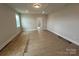 Bright bedroom featuring wood flooring, neutral walls, coffered ceilings and a doorway to another room at 3214 Mcharney Dr # 34, Harrisburg, NC 28075
