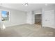 A neutral bedroom with carpeting, a window, and a door to the staircase at 3214 Mcharney Dr # 34, Harrisburg, NC 28075