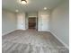Spacious bedroom featuring neutral walls and carpet, with hallway and door access at 3214 Mcharney Dr # 34, Harrisburg, NC 28075