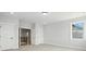 An airy bedroom with a view of the staircase and three doors at 3214 Mcharney Dr # 34, Harrisburg, NC 28075