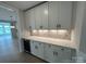 Butler's pantry with quartz countertop, wine cooler, and decorative tile backsplash at 3214 Mcharney Dr # 34, Harrisburg, NC 28075