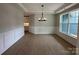 Open dining room with wainscoting, hardwood floors, and an elegant chandelier at 3214 Mcharney Dr # 34, Harrisburg, NC 28075