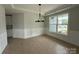 Chic dining area featuring modern light fixtures, wainscoting, and lovely hardwood floors at 3214 Mcharney Dr # 34, Harrisburg, NC 28075