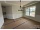 Dining room features modern chandelier, wainscoting, and a large window at 3214 Mcharney Dr # 34, Harrisburg, NC 28075