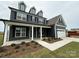 Beautiful two-story home featuring a welcoming porch, dark siding, and a well-maintained front yard at 3214 Mcharney Dr # 34, Harrisburg, NC 28075